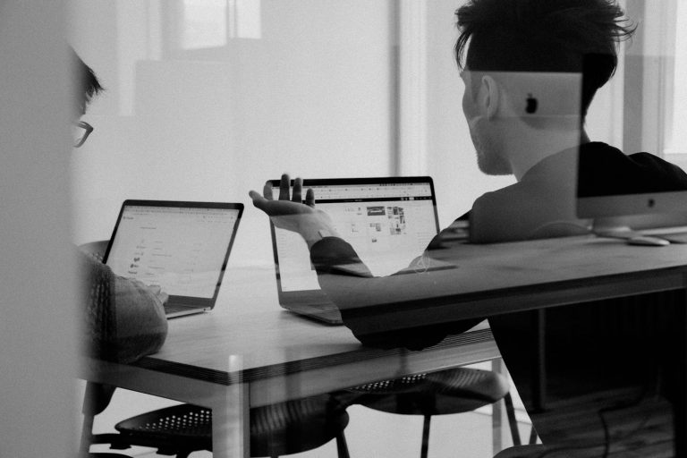 Team discussing online brand strategy around a table