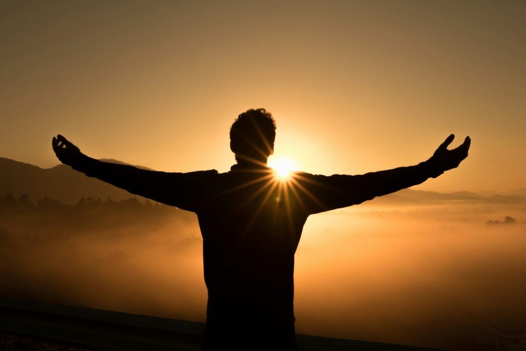 Person pausing outdoors while reflecting on a next step